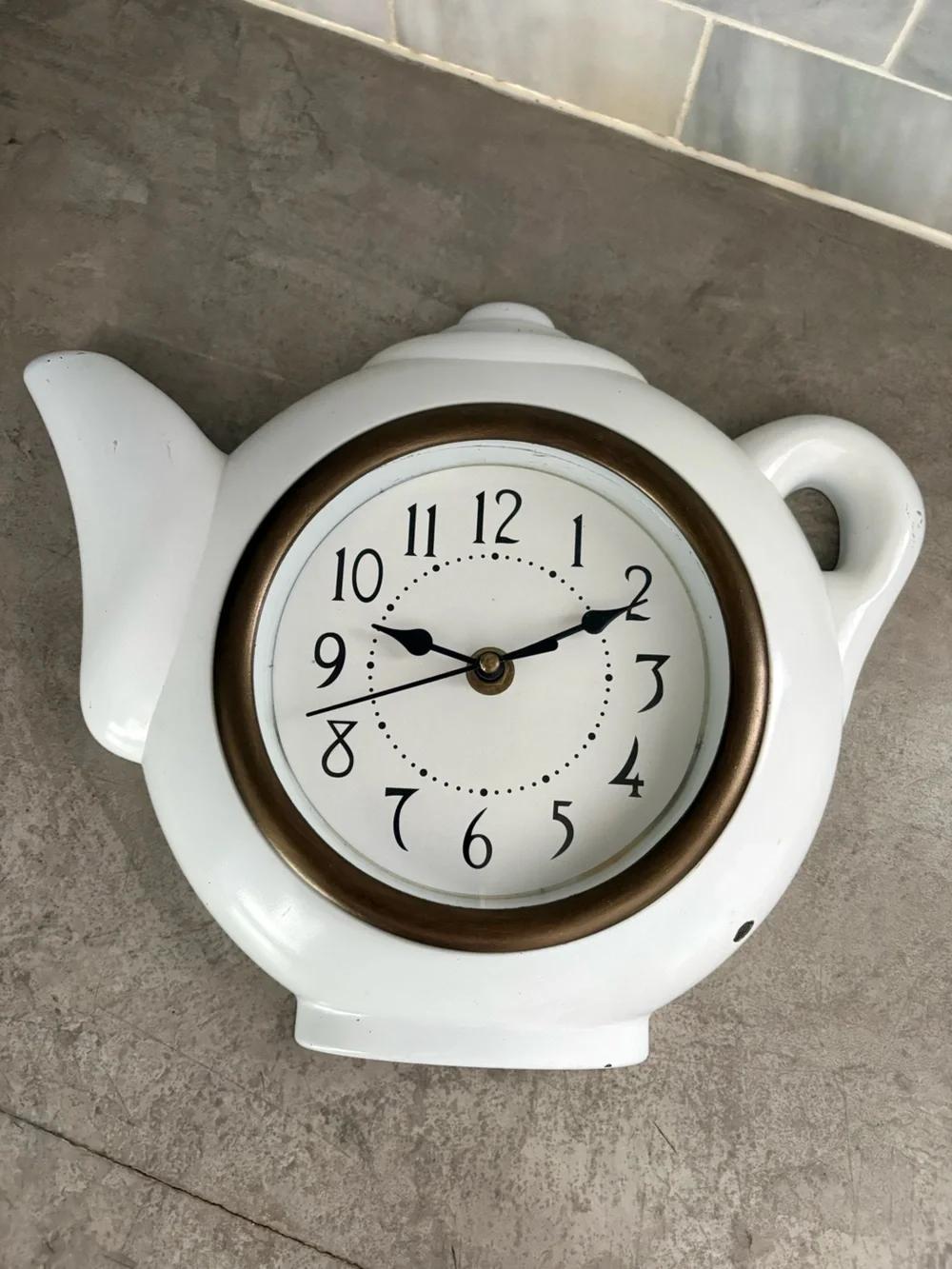 vintage teapot clock styled with a glossy white finish to look like ceramic.